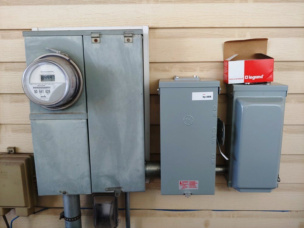 An electrical panel with a meter and a box that says legrand on it