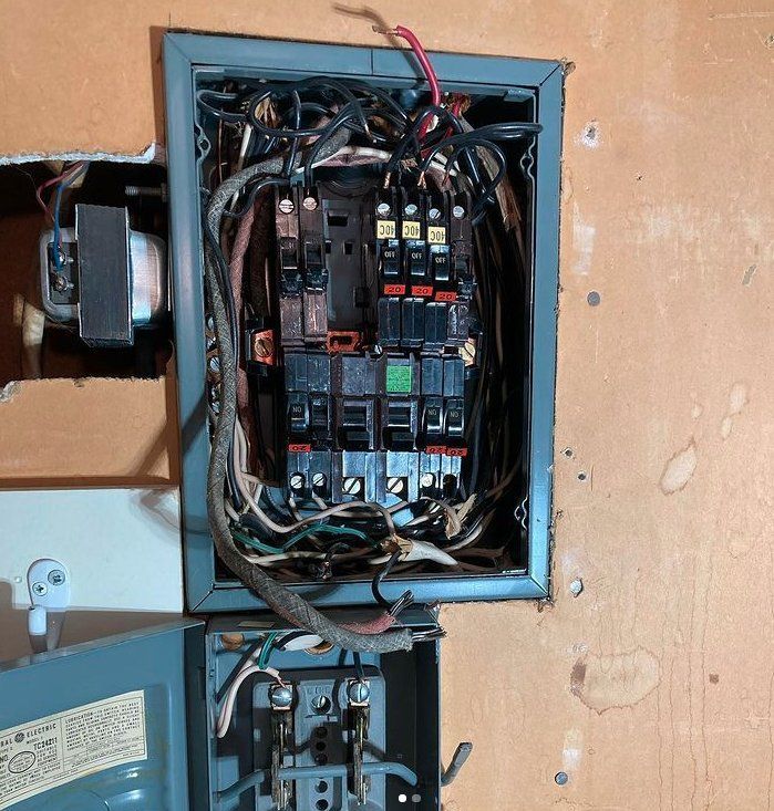 An electrical box with a lot of wires coming out of it