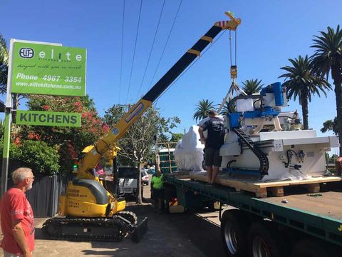 Crane Putting a Vehicle on Truck — Crane Hire  in Carrington, NSW