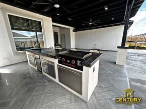 A large kitchen with a grill and a stove top oven.