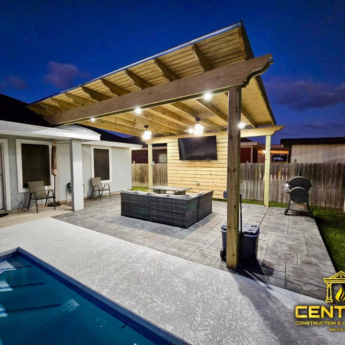 A patio with a pergola and a swimming pool in the backyard.