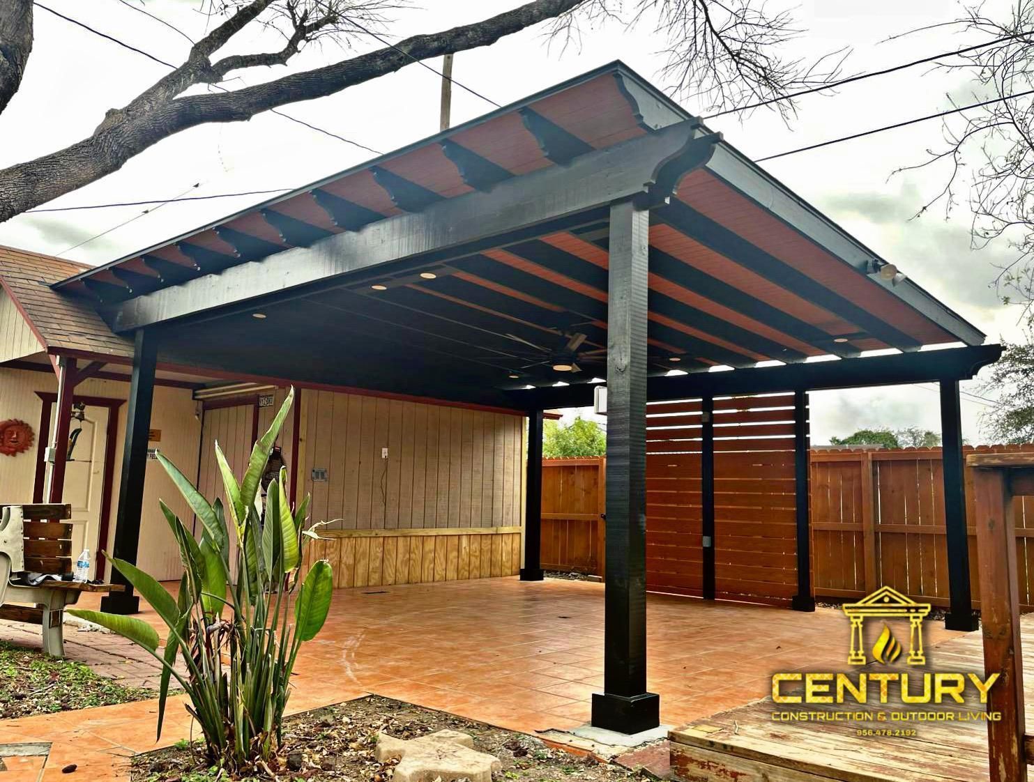 A carport with a pergola and a fence in front of a house.