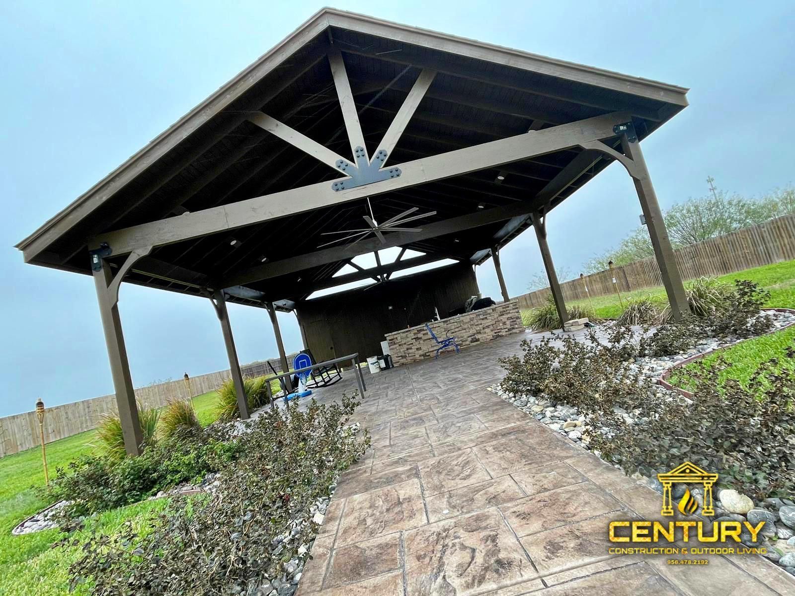 A wooden pavilion with a stone walkway leading to it.