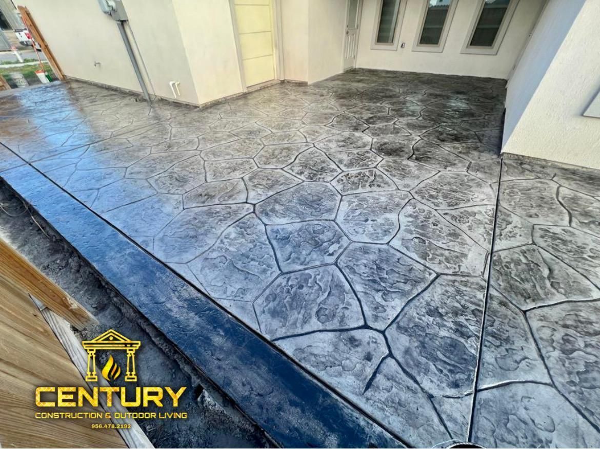 A concrete patio is being installed in front of a house.