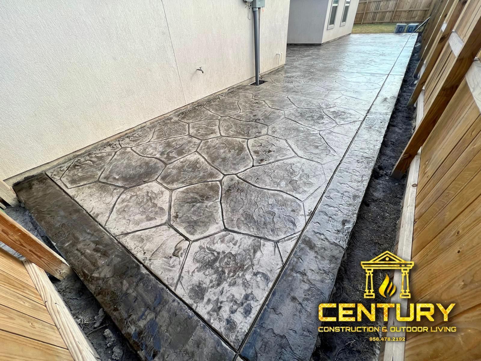 A concrete walkway is being built in front of a house.