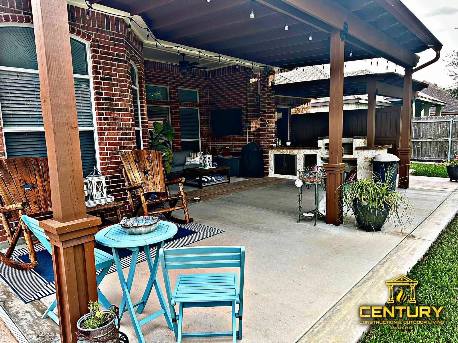 A patio with a table and chairs under a covered patio.