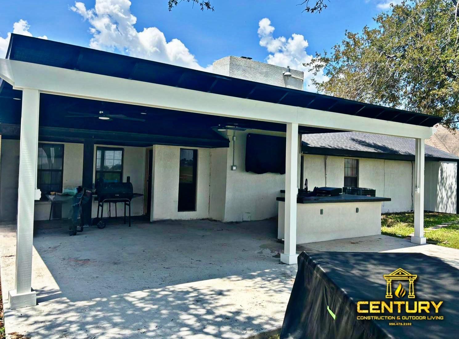 A white house with a black roof and a century logo on the side
