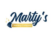 Logo for "Marty's Cleaning Company" with cursive navy text, a broom icon, and gold elements.
