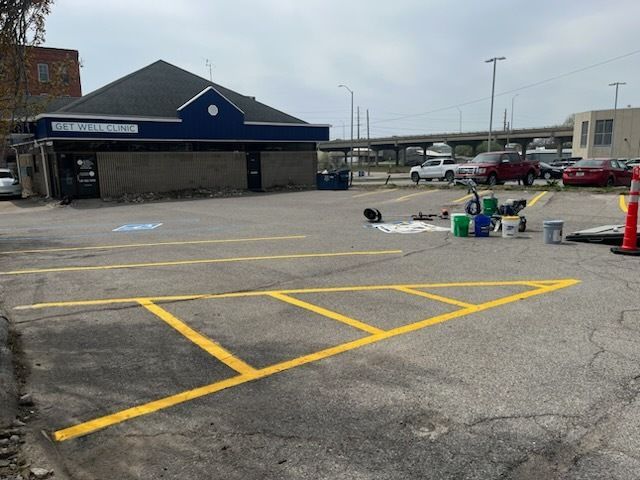 A parking lot with a blue building in the background