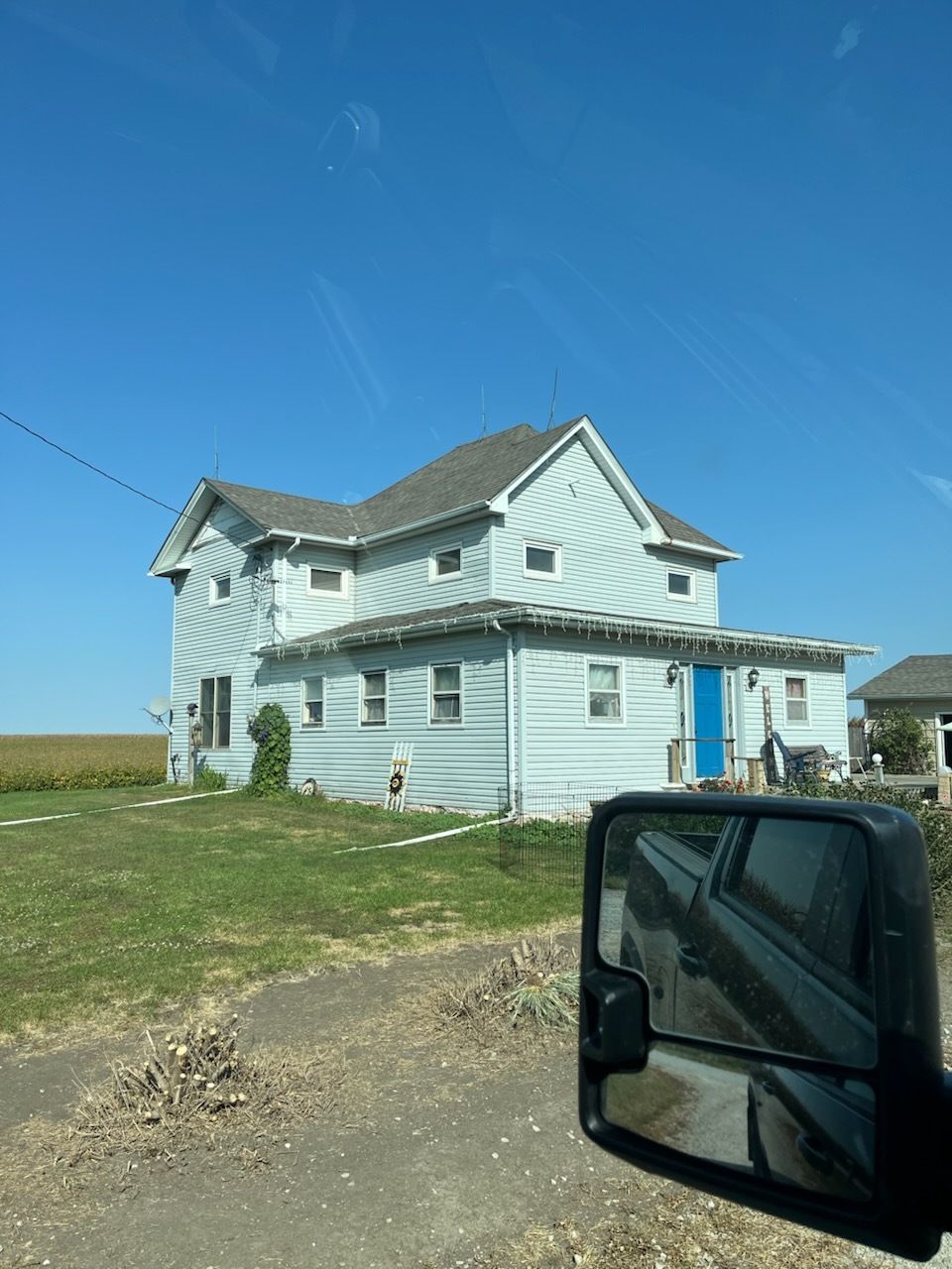 A house with a ladder in front of it is being remodeled.
