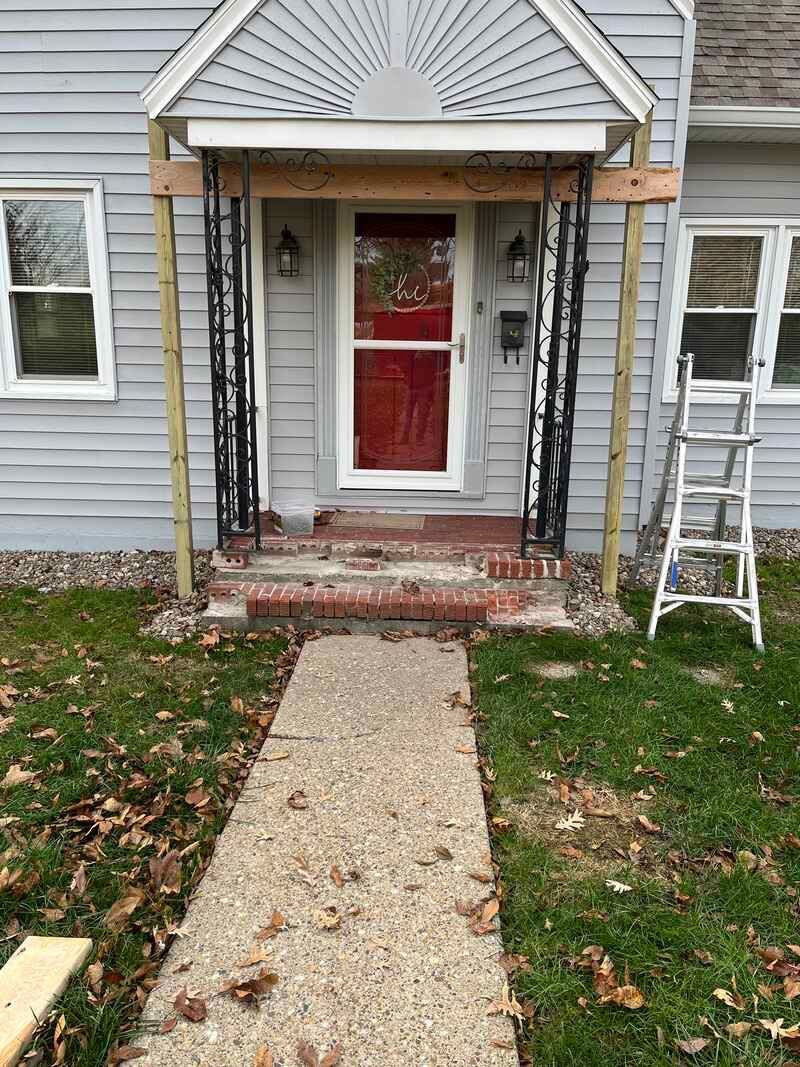 A porch is being built on the front of a house.
