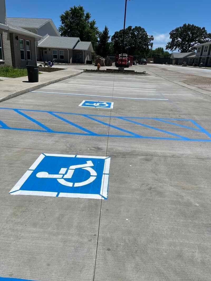 A parking lot with a handicap sign painted on the ground