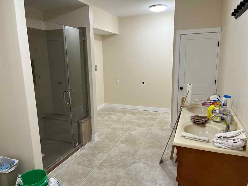A bathroom with a sink , toilet and shower.