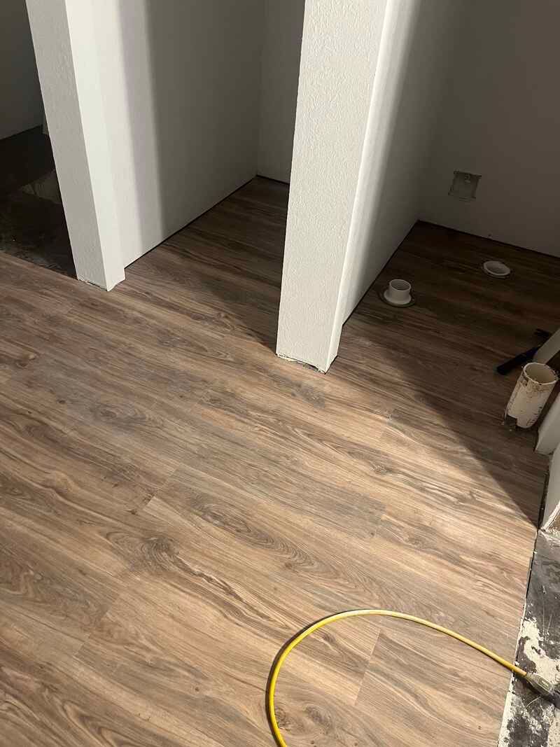 A wooden floor is being installed in a room.