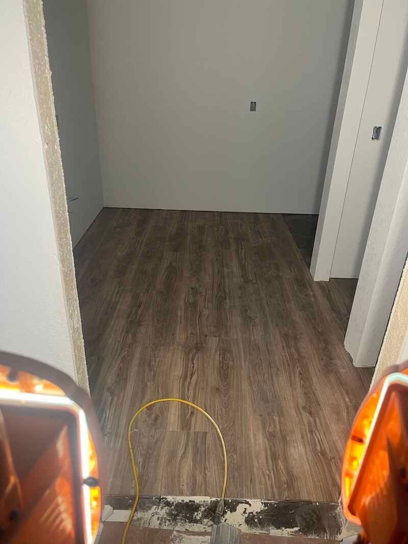 A room with a wooden floor and a door.