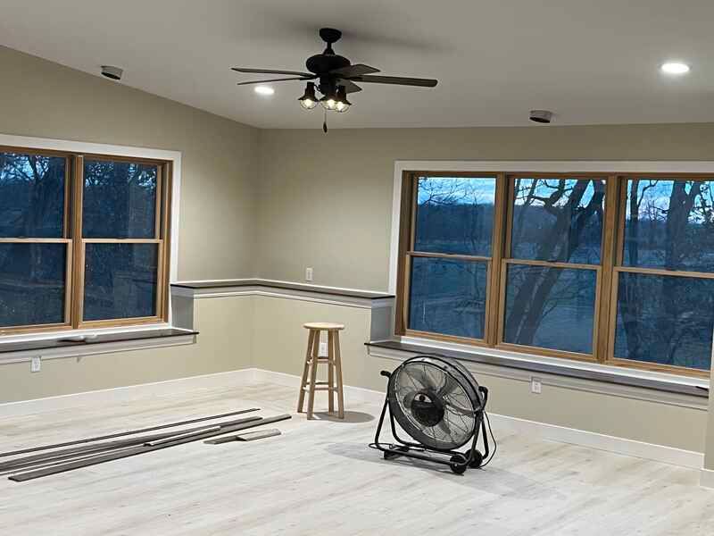 There is a ceiling fan in the middle of the room.