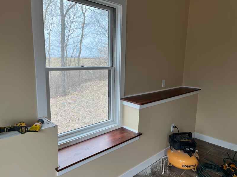 A room with a window and a air compressor in it.