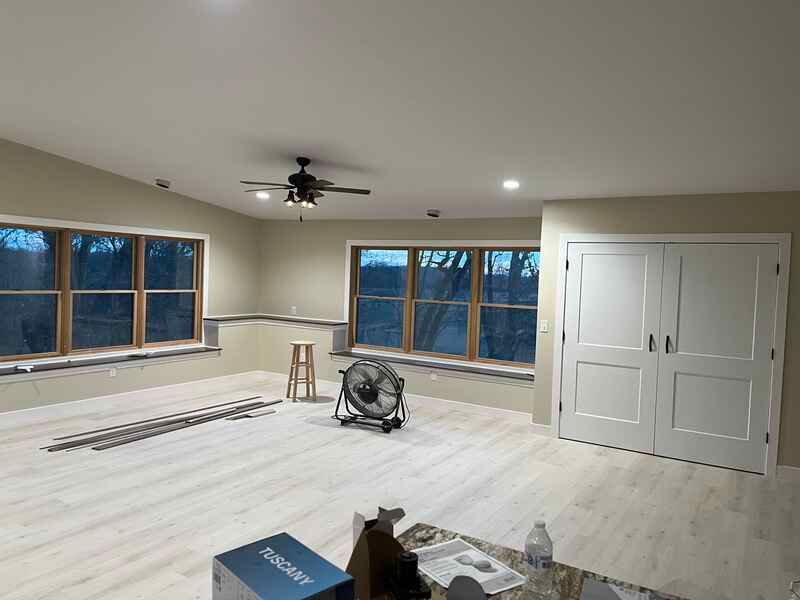 There is a ceiling fan in the middle of the room.