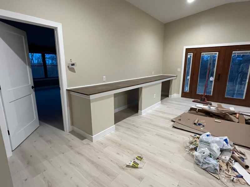 A room with a desk and a door in it.