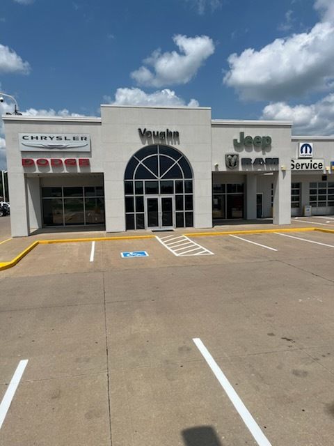 A chrysler and jeep dealership with a handicapped parking spot