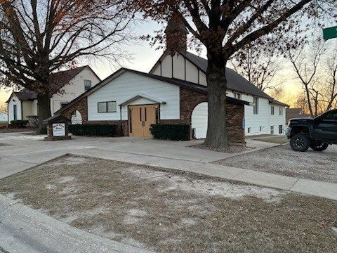 A truck is parked in front of a church.
