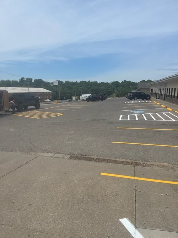 A parking lot with a handicapped parking spot in the middle