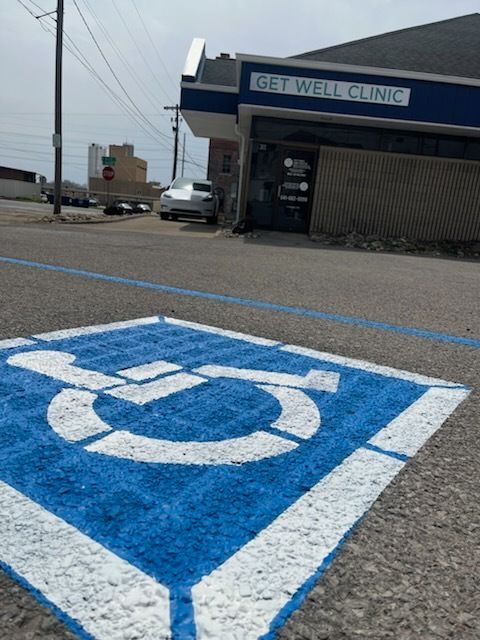 A handicapped parking spot in front of a get well clinic
