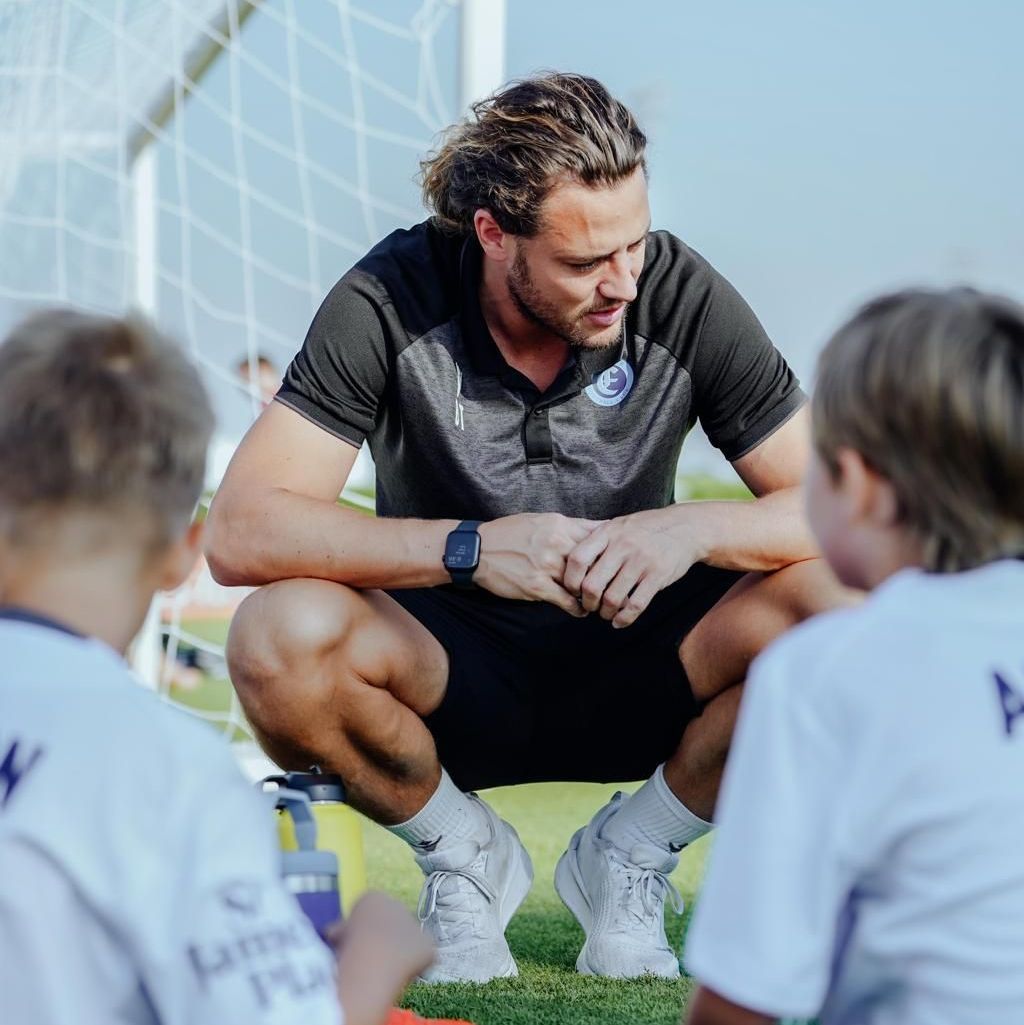 A group of young boys are playing soccer on a field.
