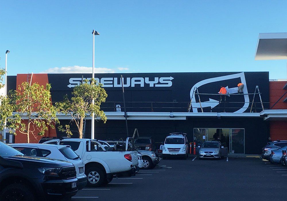 Side Ways Hand Painted Signage Outlet with Two Men Painting on a Logo —  Hand Painted Signs in Tweed Heads South, NSW