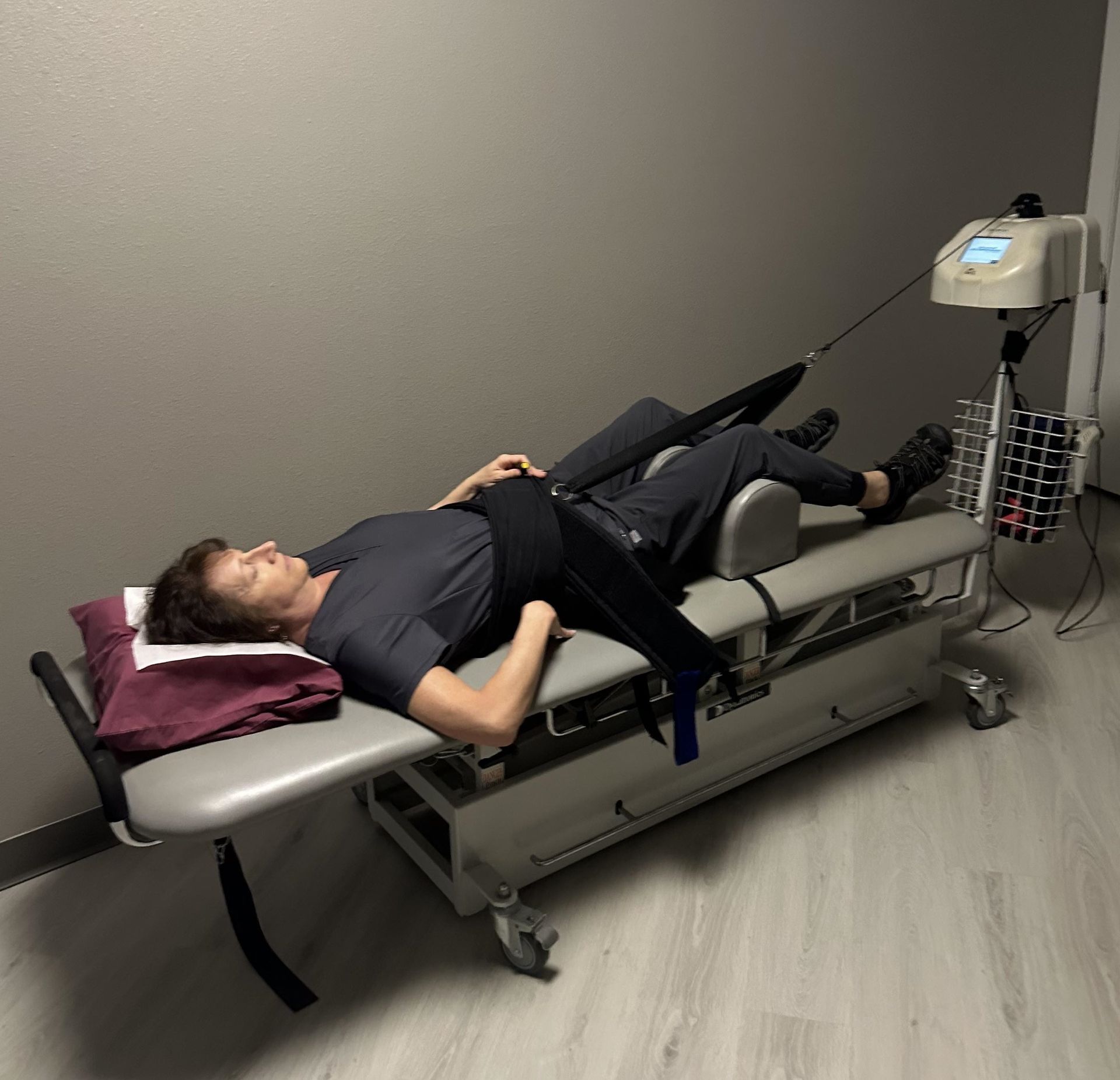 A man is laying on a stretcher in a room