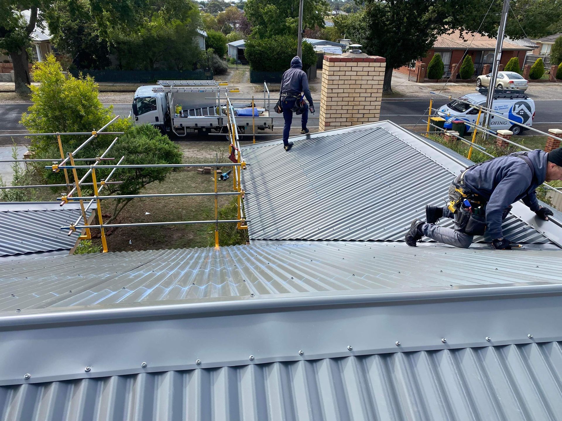 A Couple Of People Are Working On A Roof — iFix Roofing Geelong In South Geelong, VIC