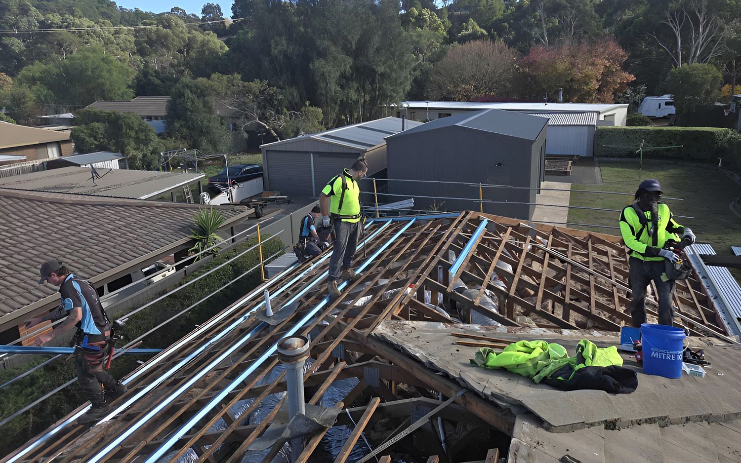 Three Construction Workers Repairing Roof