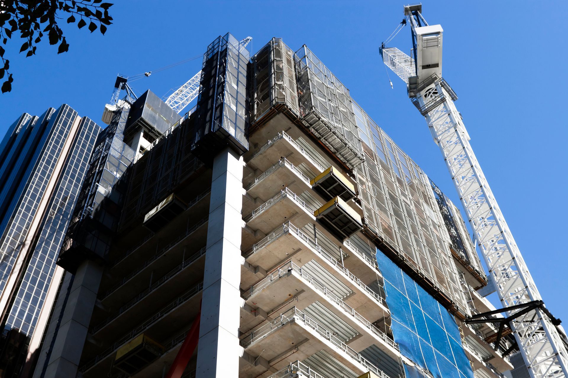 A building under construction with a blue sky in the background