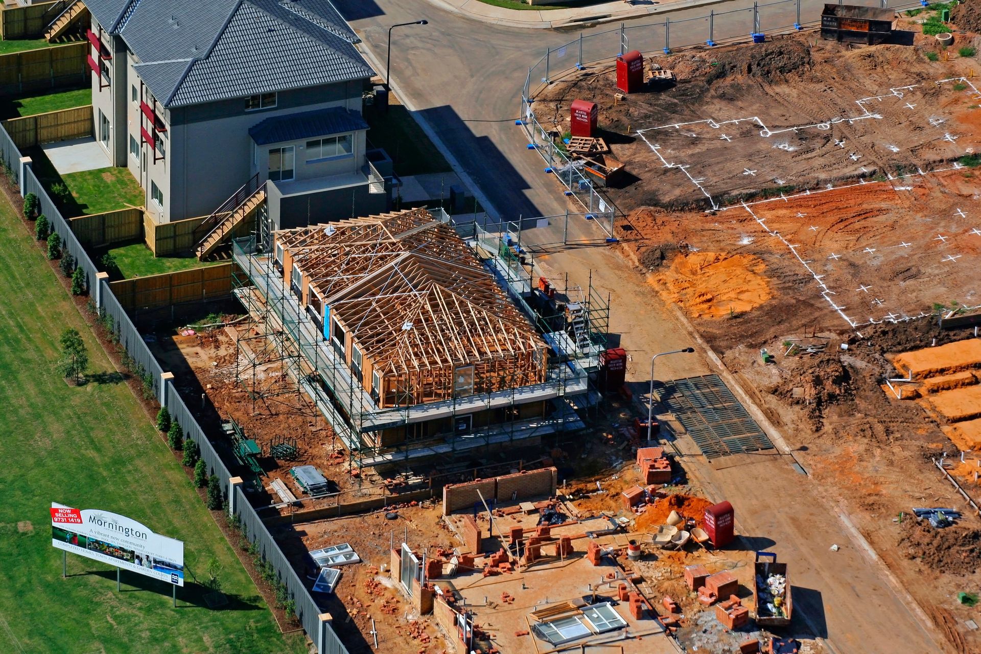 An aerial view of a house under construction in a residential area
