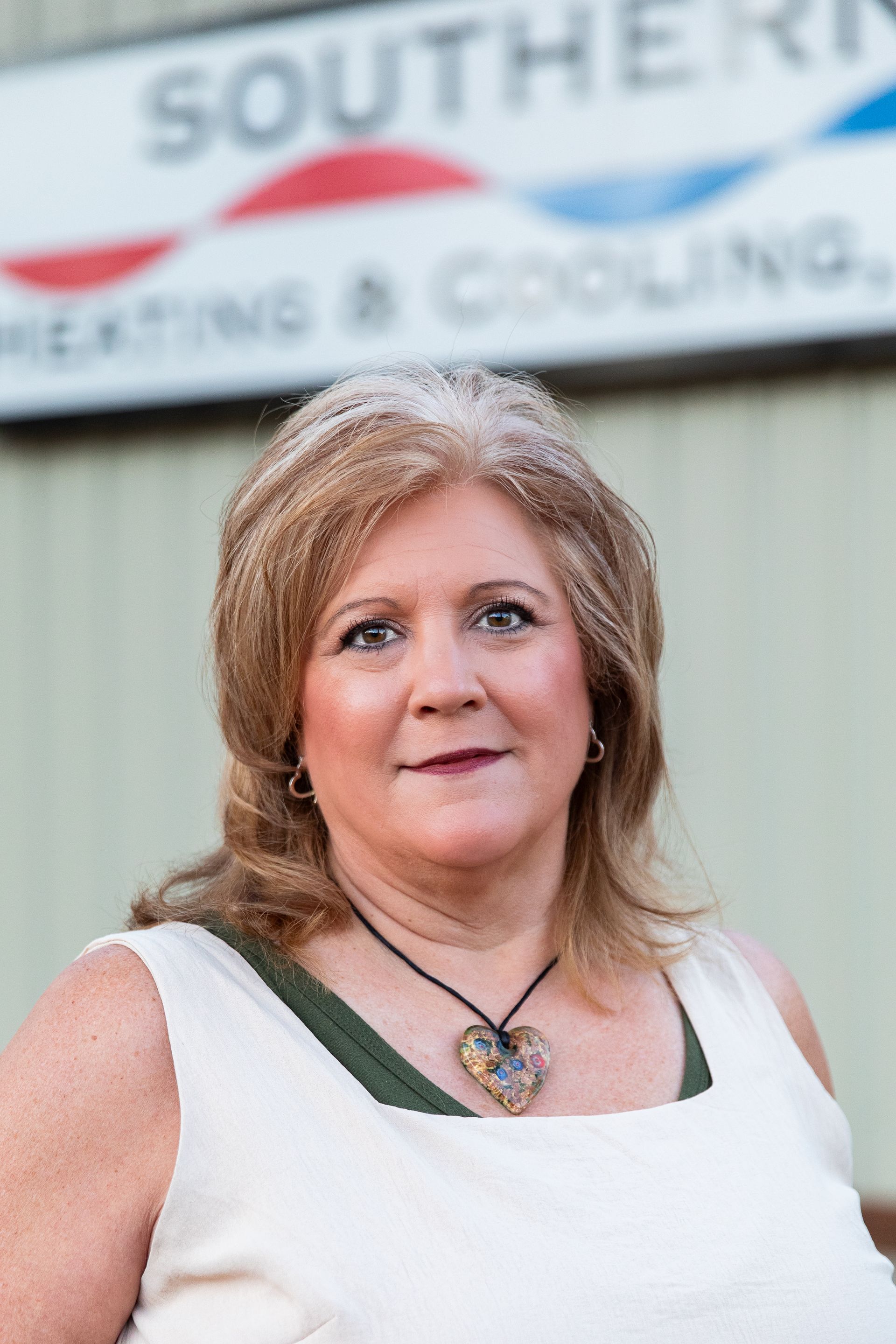 Four people stand outside a building with 