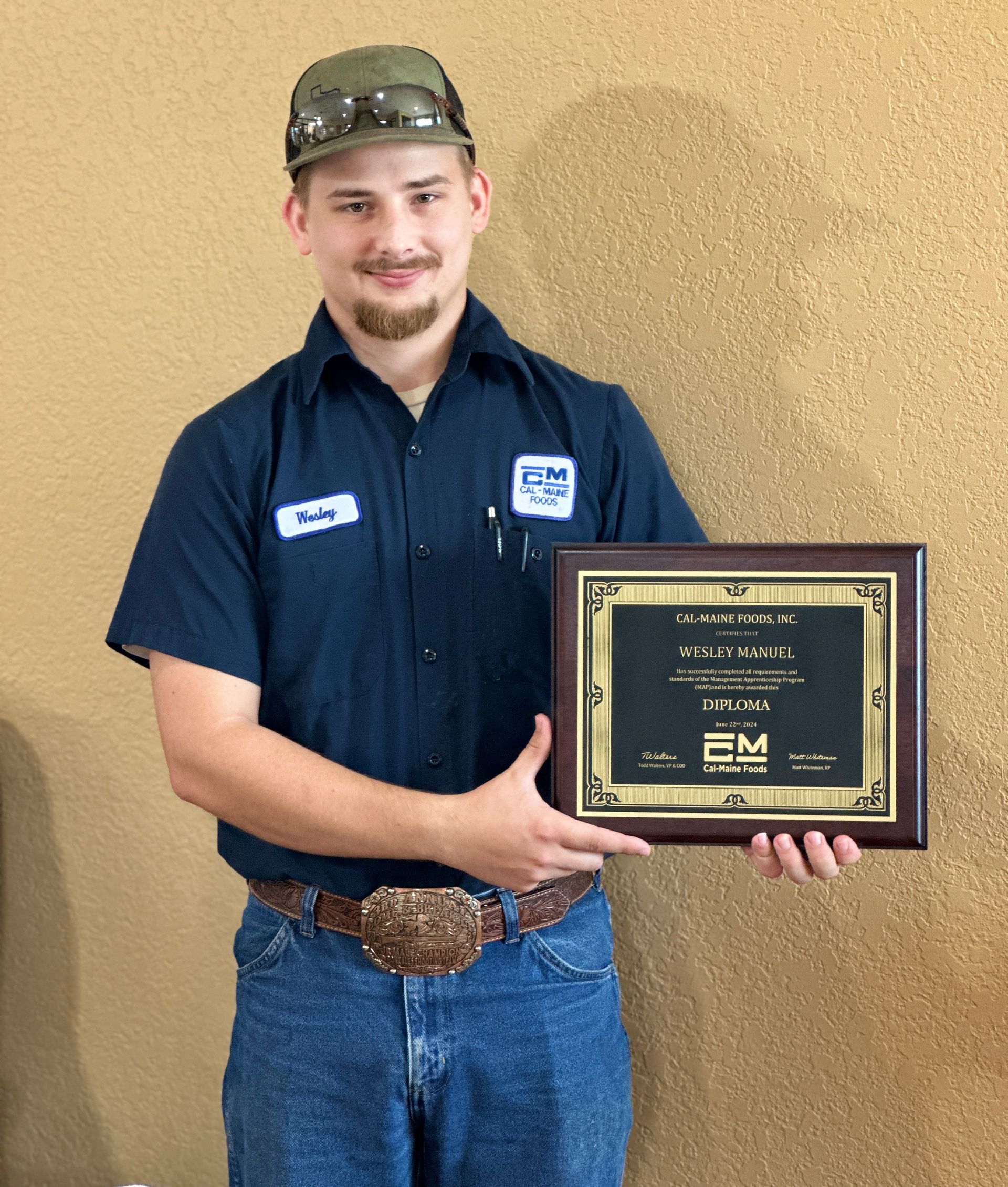 Cal-Maine Foods employee Wesley Manuel, receiving his diploma as the first graduate of the Company’s new Management Apprenticeship Program.