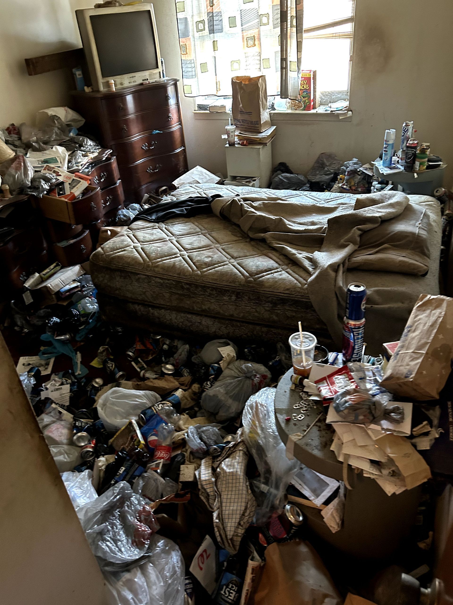 A before shot of a bedroom from a hoard cleanup in Ohio by Kingdom Bio Recovery & Restoration