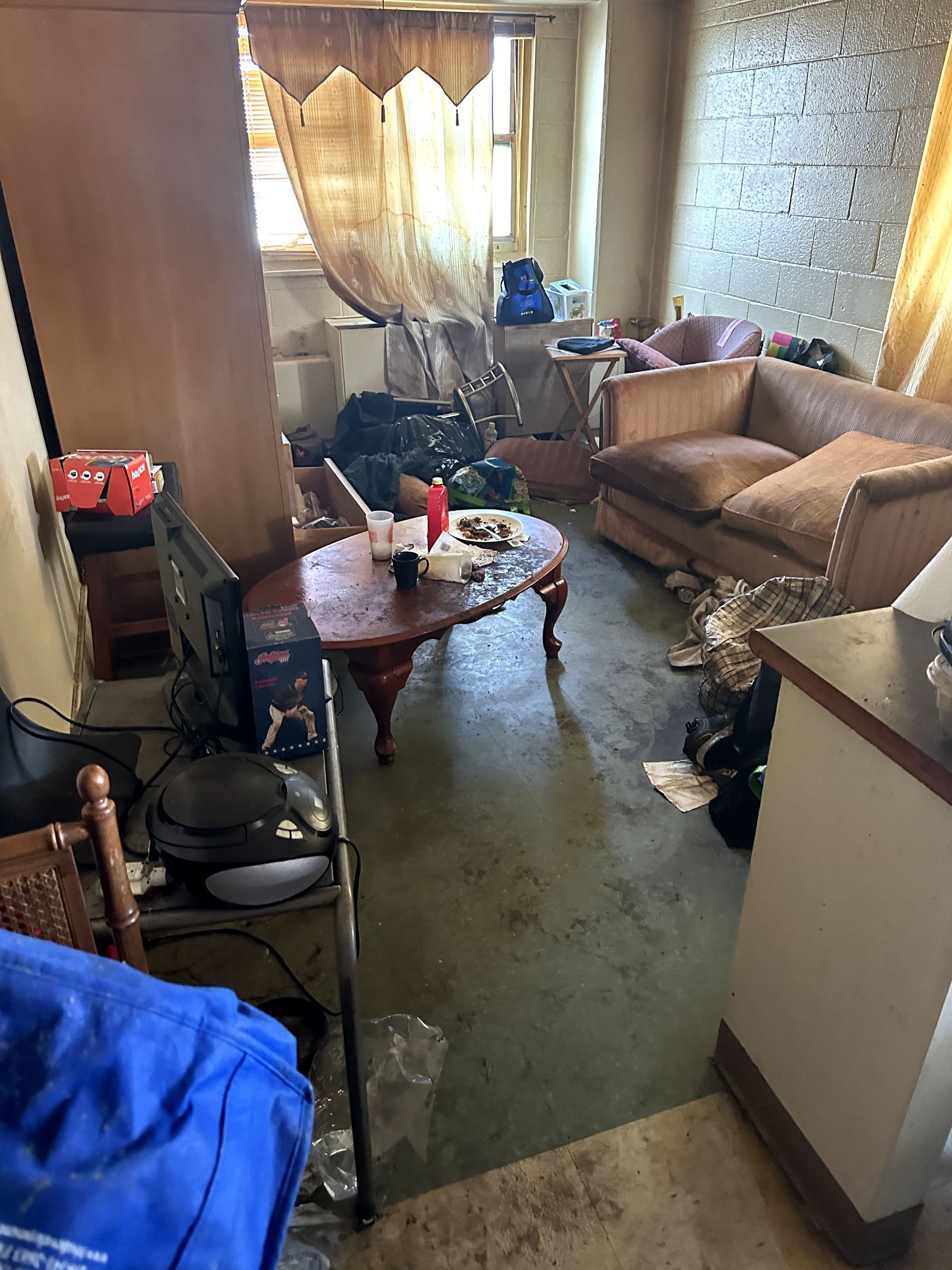 A before shot of a living room in a hoard cleanup in Ohio by Kingdom Bio Recovery & Restoration