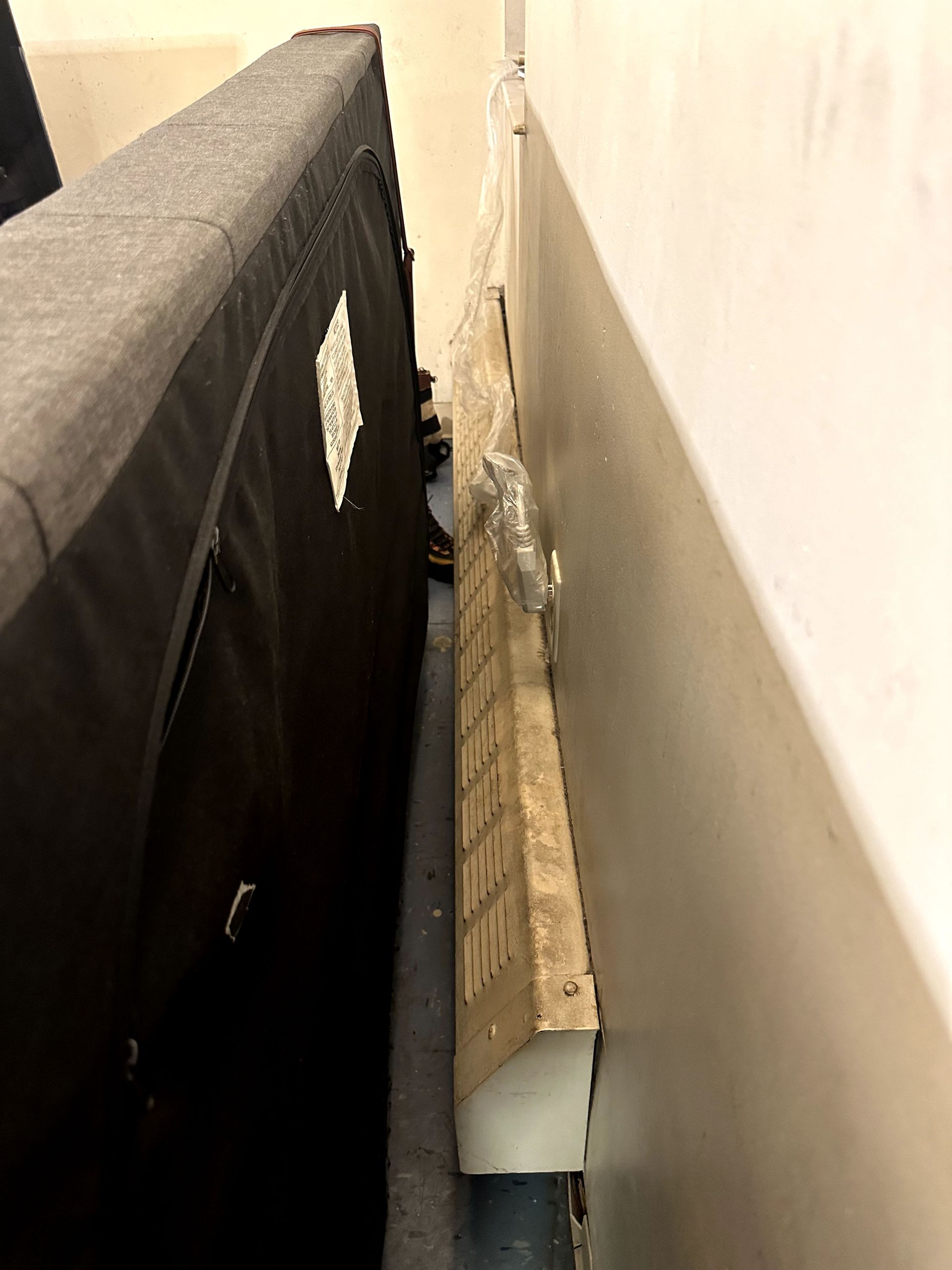 A before shot of behind a couch from a hoard cleanup in Pittsburgh, PA by Kingdom Bio Recovery & Restoration