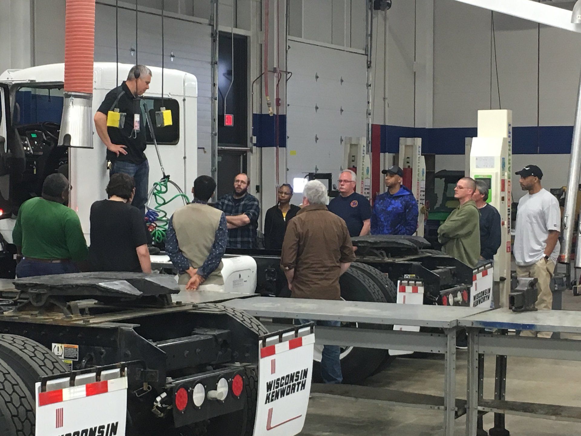 CDL class in the lab receiving hands on demonstration of an inspection of a day cab semi truck