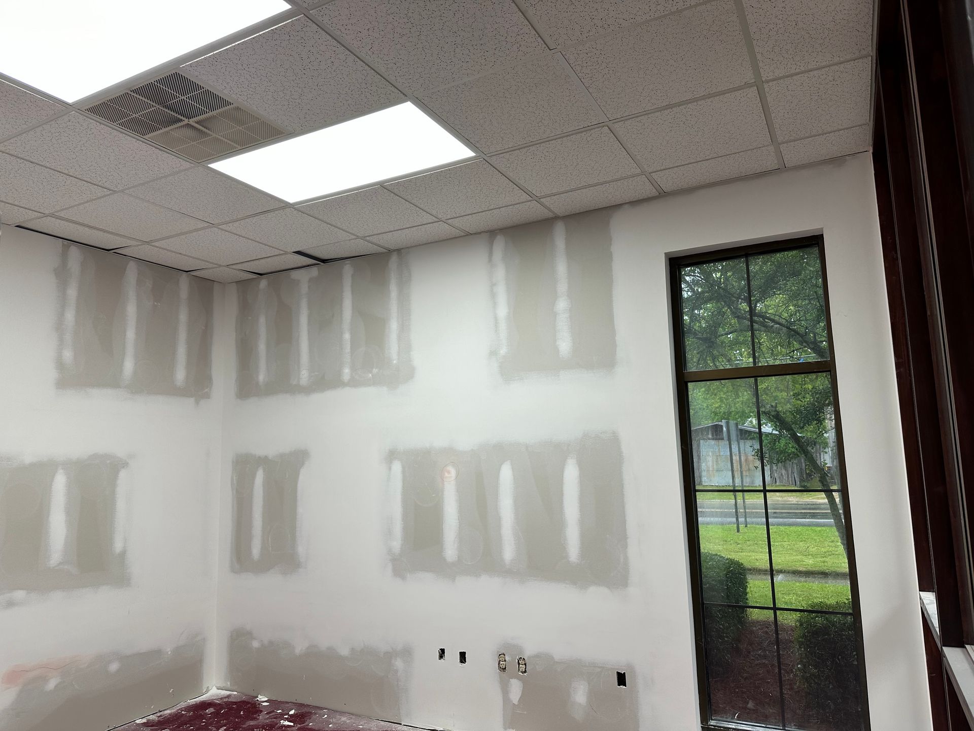 A room with a lot of white walls and a window