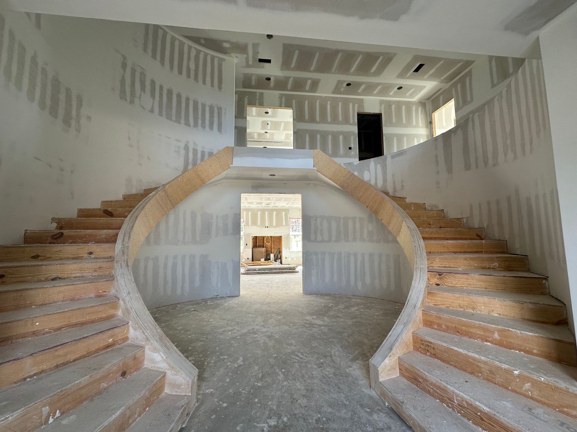 A curved staircase in a building under construction