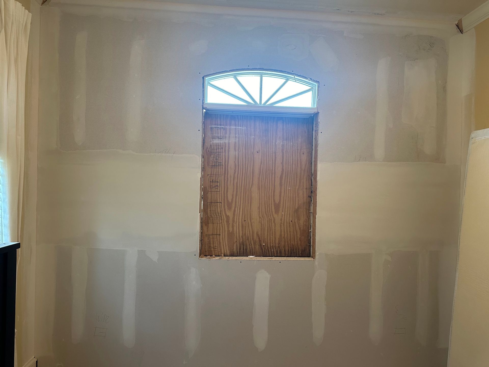 A room with a window in the middle of the wall.