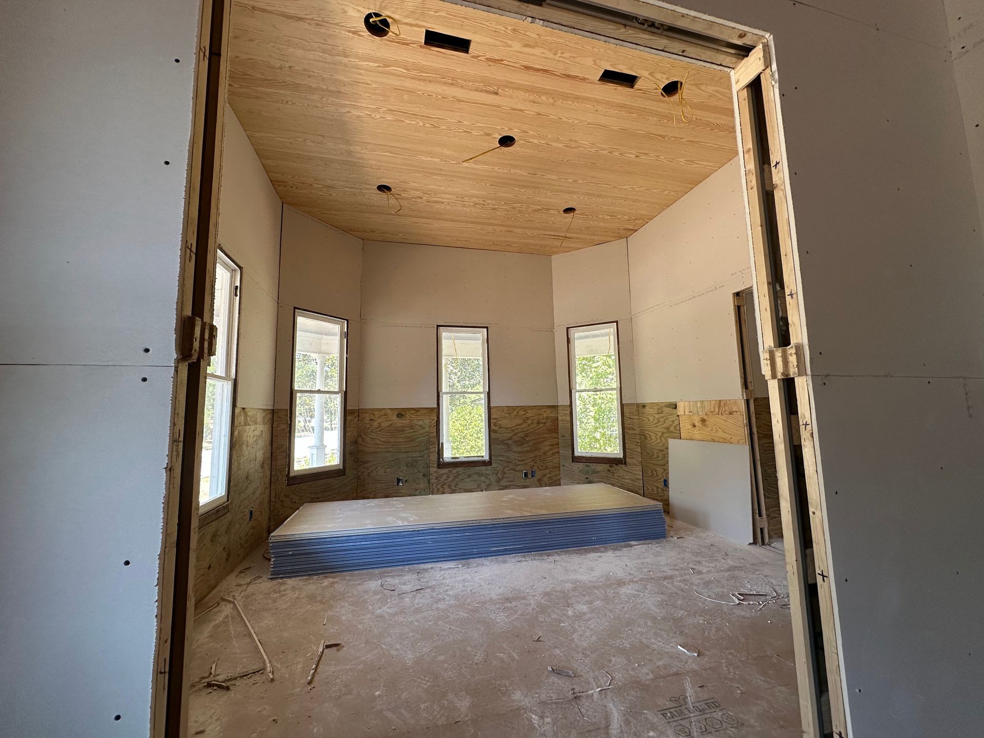 An empty room with a mattress in the middle of it