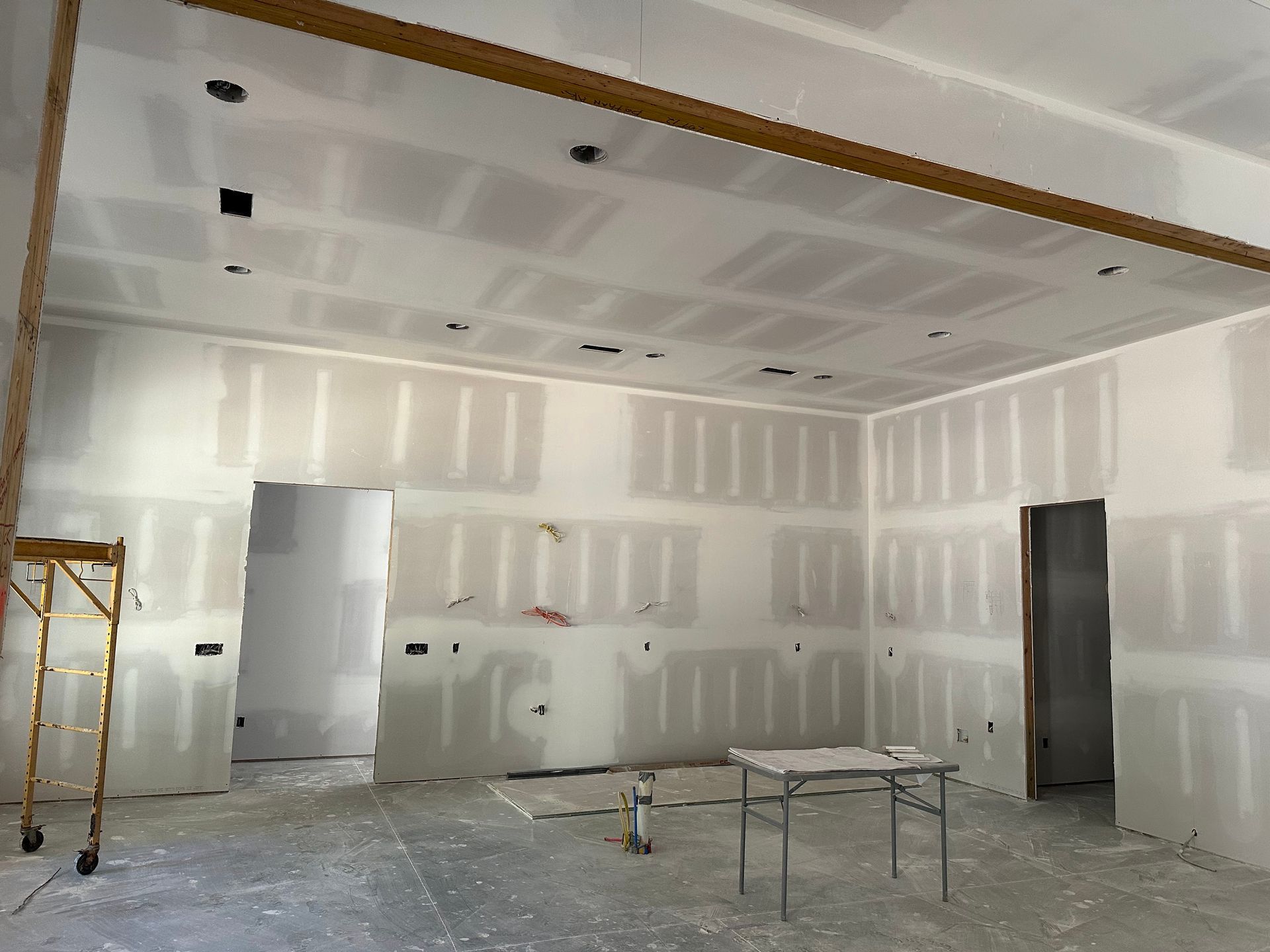 An empty room with a table and scaffolding in it