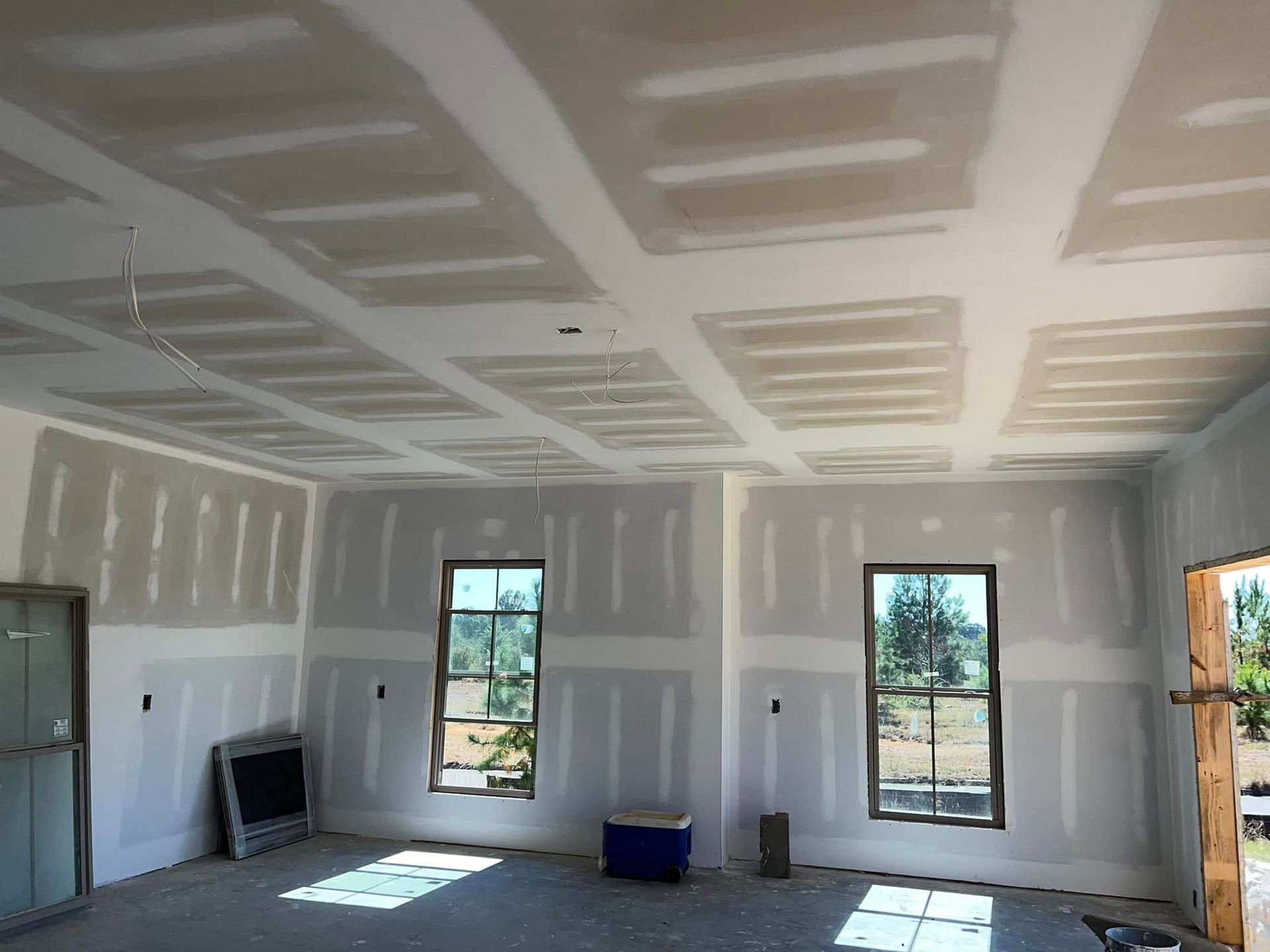 A room with a lot of drywall on the walls and ceiling.