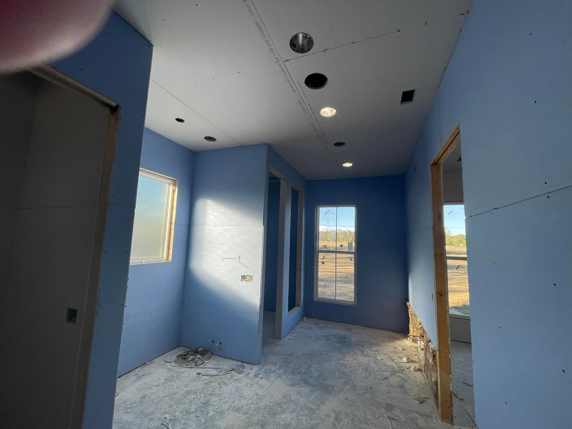 A room with blue walls and a white ceiling