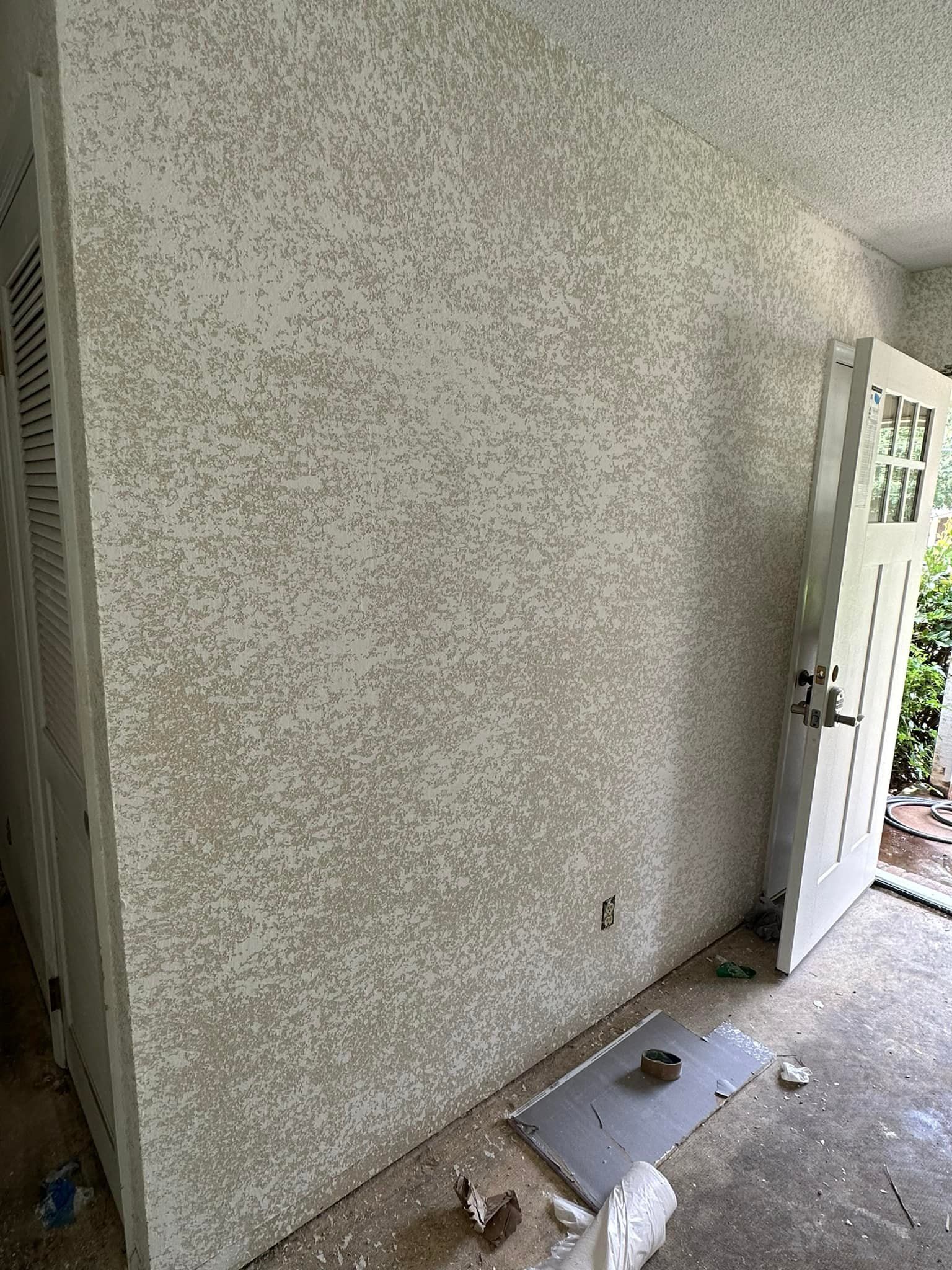 A room with a white wall and a white door.