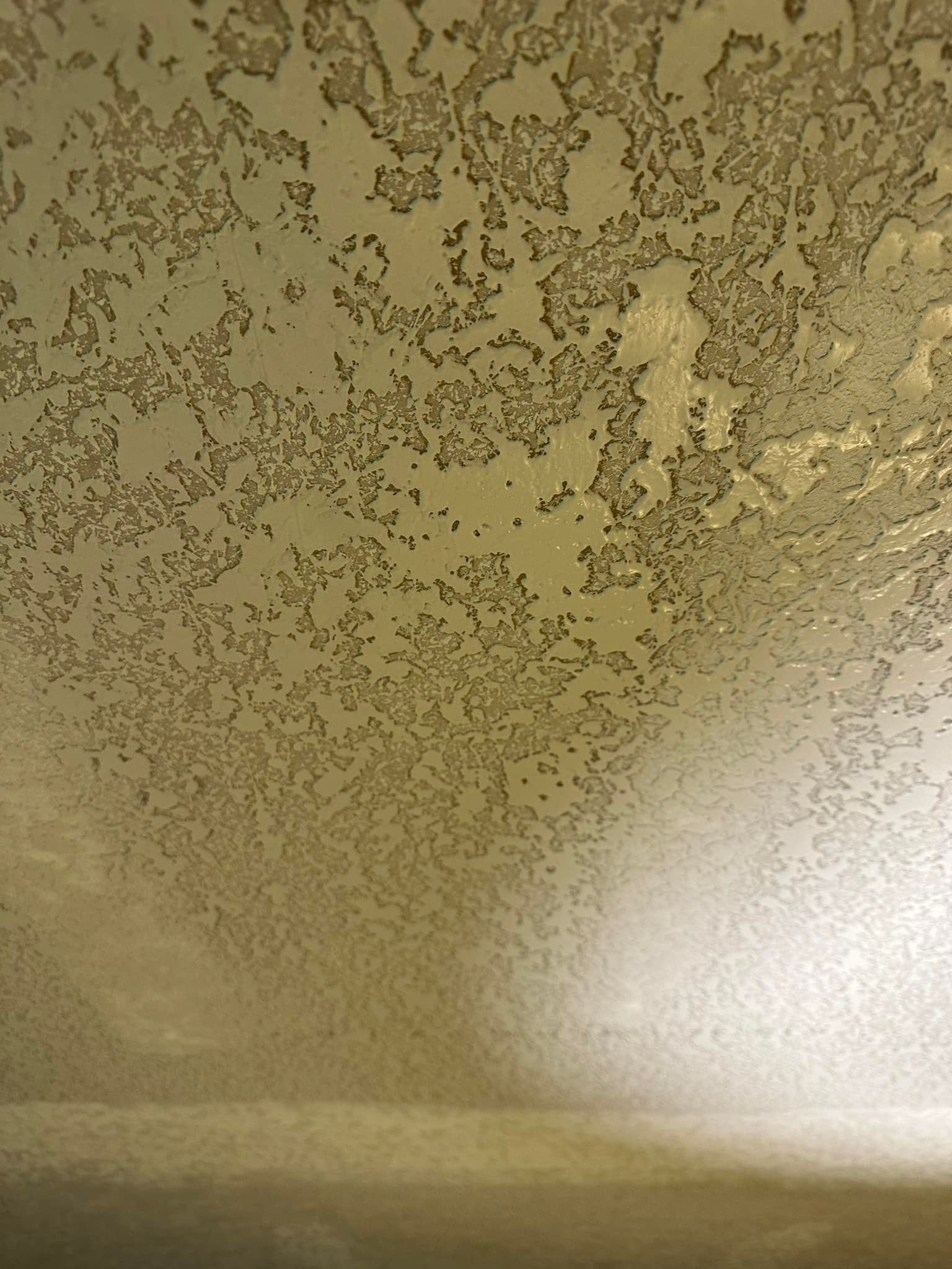 A close up of a gold colored surface with a texture