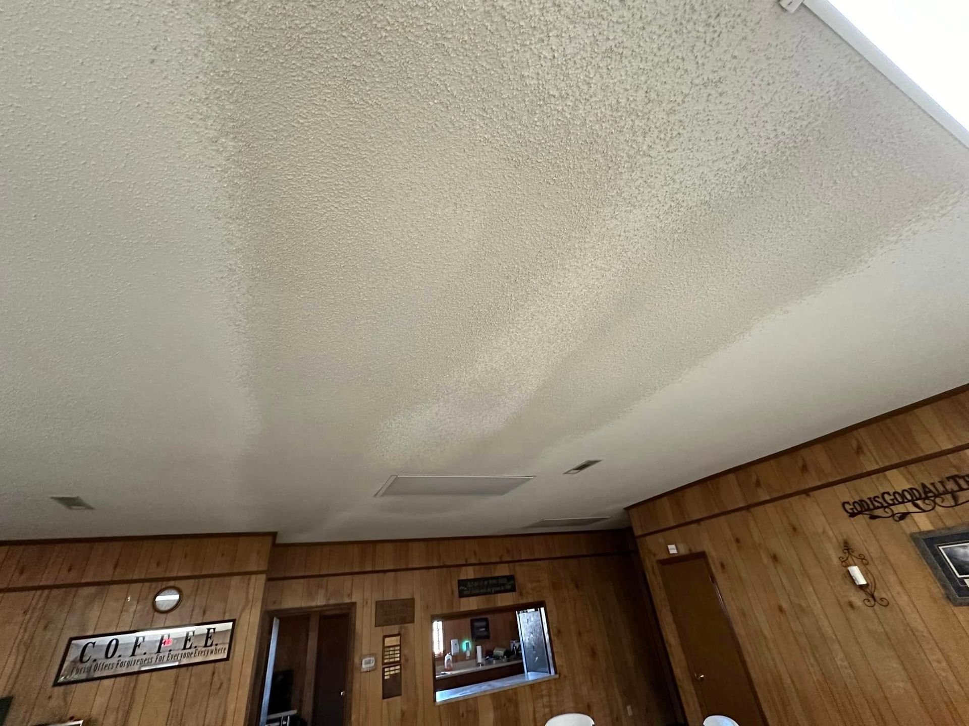A room with wood paneling and a white ceiling.